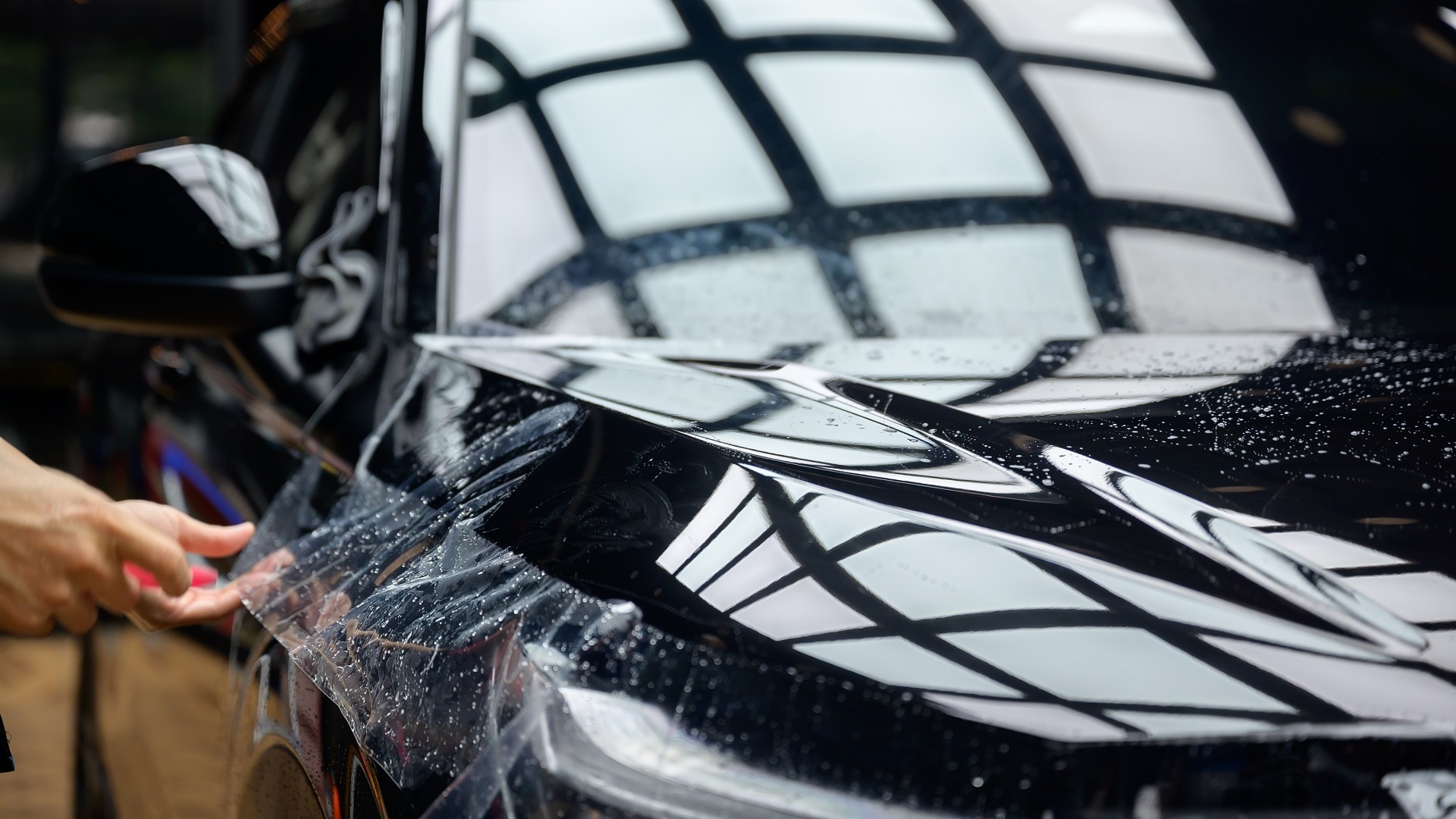 A,Worker,Is,Applying,Transparent,Film,To,A,Car,To